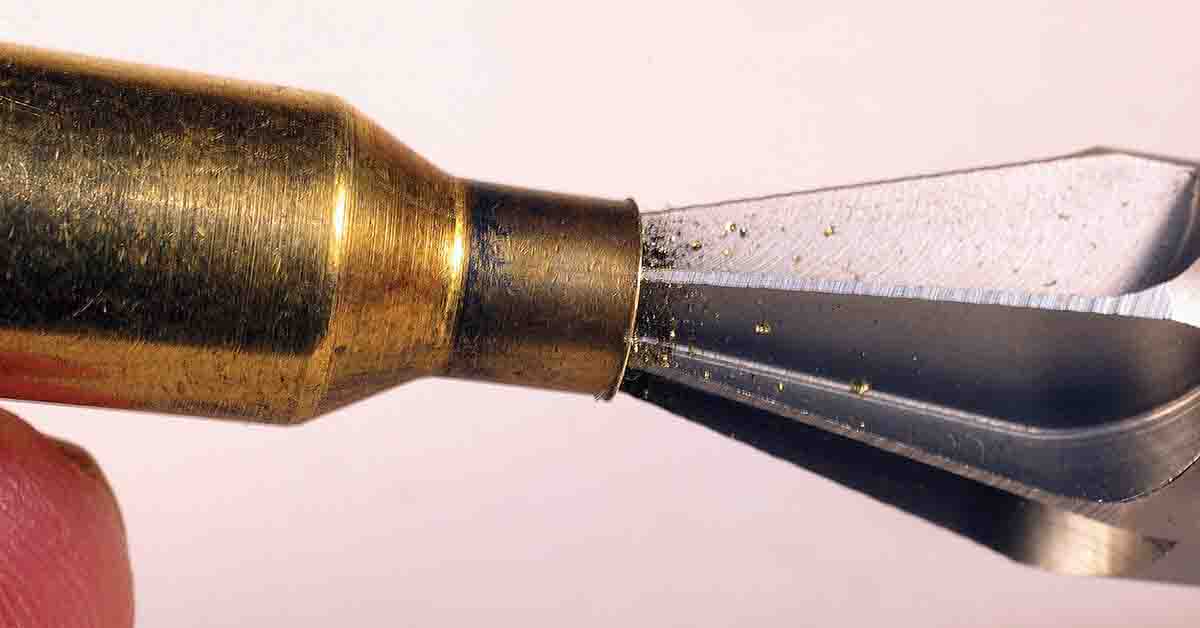 An inside chamfer tool cuts off the burrs of brass remaining after trimming.